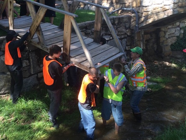 River restoration crew installs bridge over Santa Fe River.