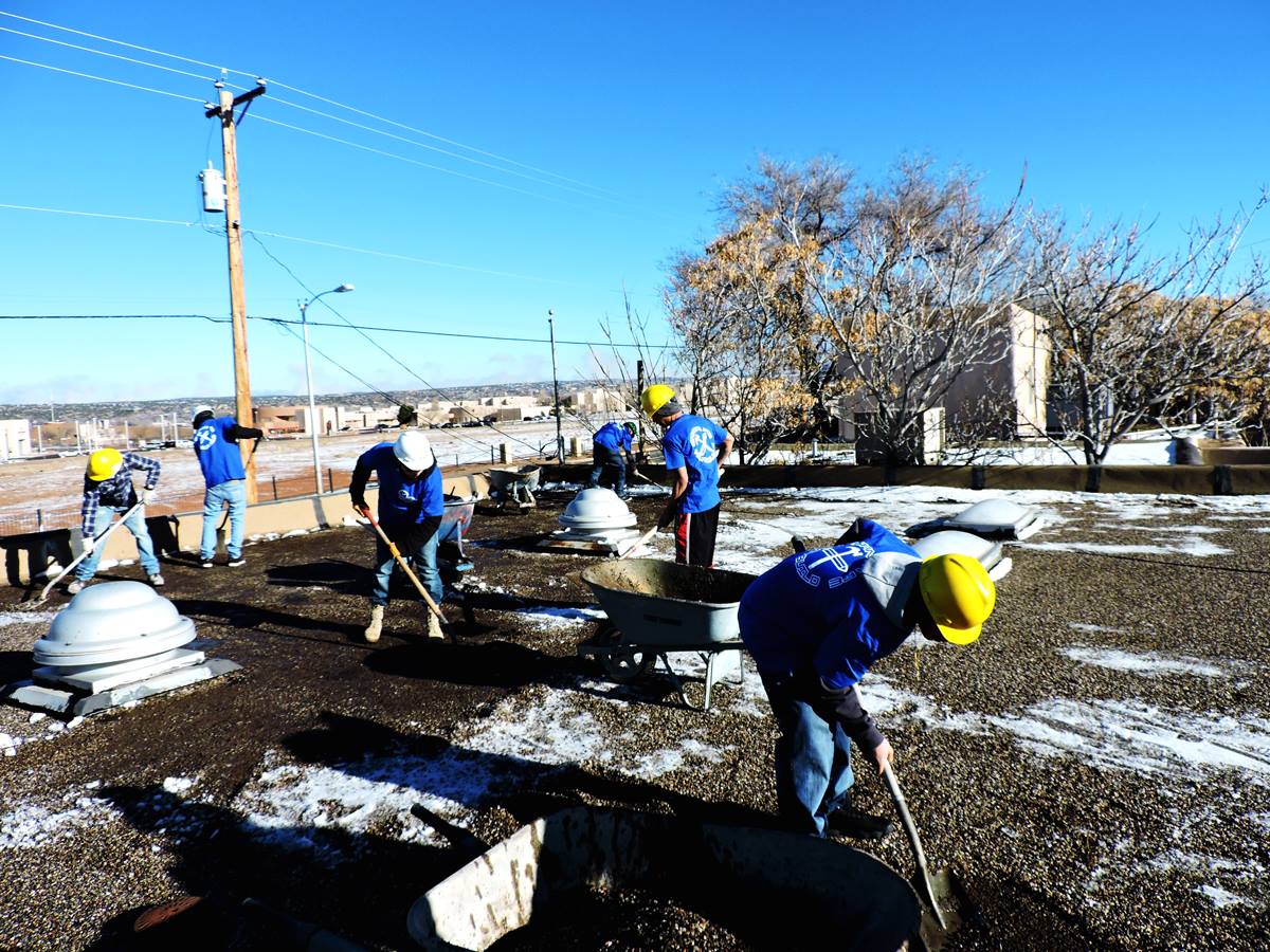 The YouthBuild crew is hard at work removing the old roof from the ¡YouthWorks! building.