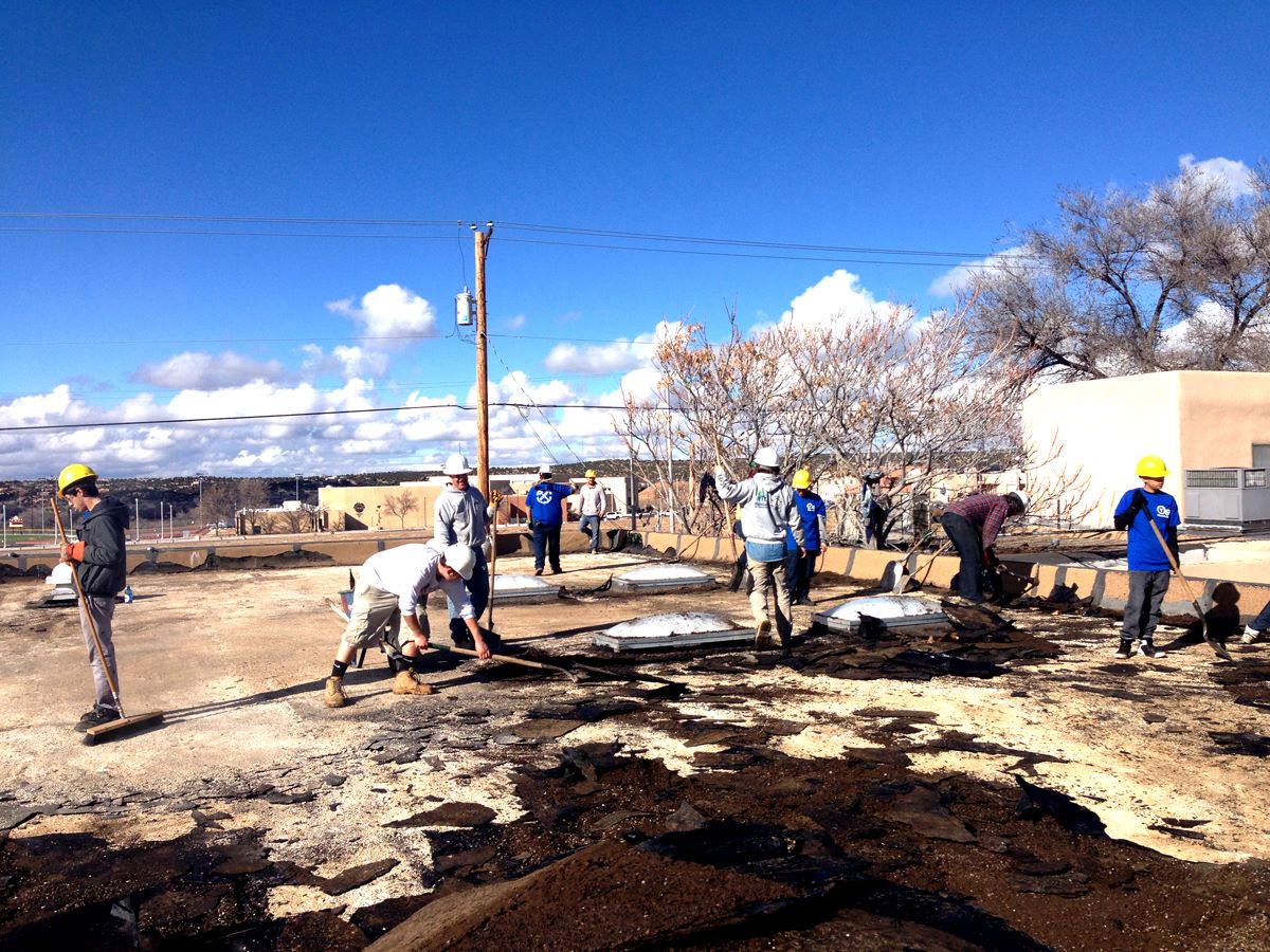 The YouthBuild crew removes the old roof from the ¡YouthWorks! building.